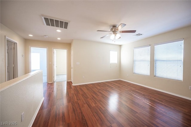 spare room featuring ceiling fan and dark hardwood / wood-style flooring