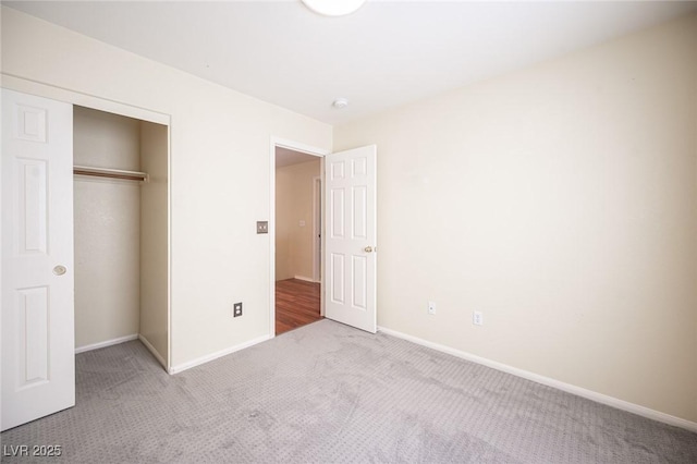 unfurnished bedroom with carpet flooring and a closet