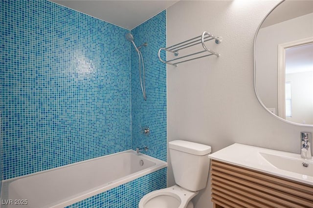 full bathroom with vanity, tiled shower / bath combo, and toilet