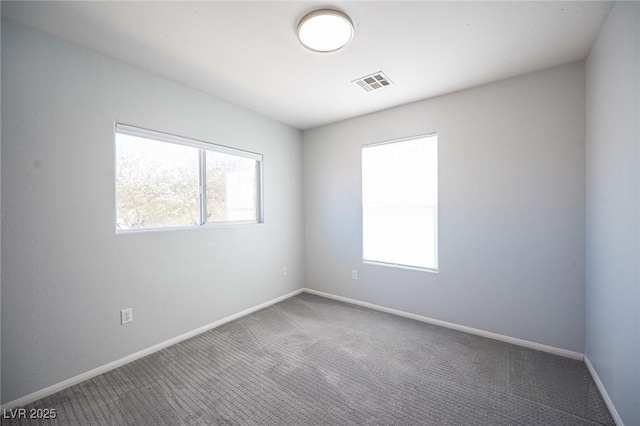 spare room featuring carpet floors and a healthy amount of sunlight