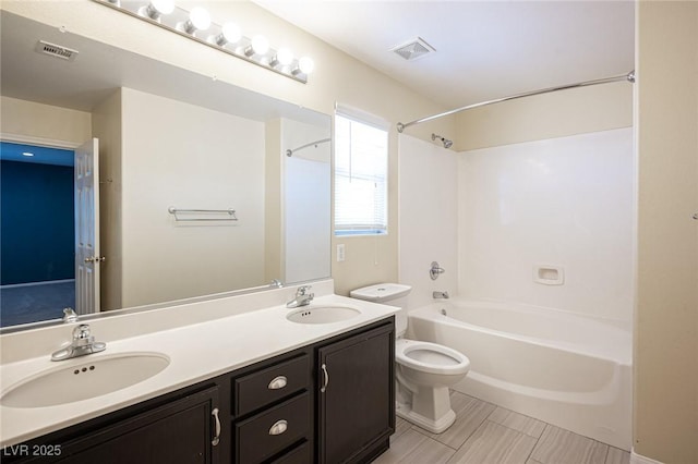 full bathroom featuring vanity, shower / bath combination, and toilet