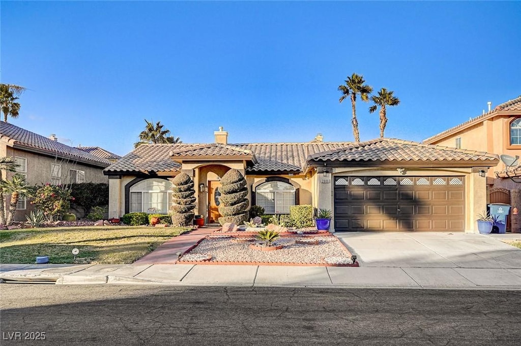 mediterranean / spanish-style home with a garage