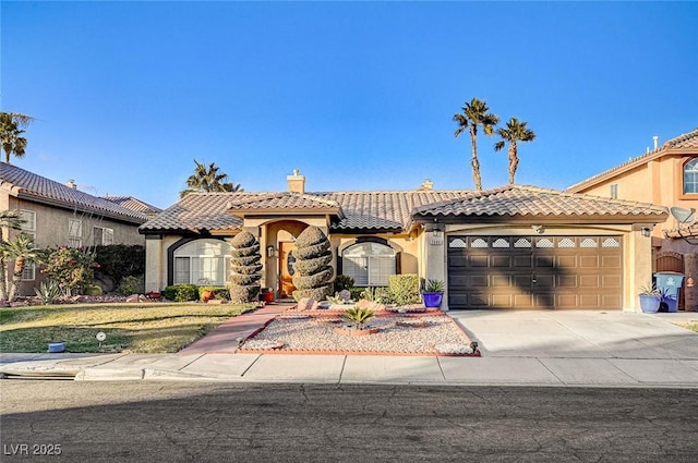 mediterranean / spanish-style home with a garage