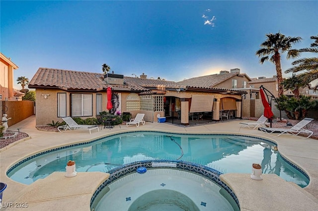 view of pool with a patio area and an in ground hot tub