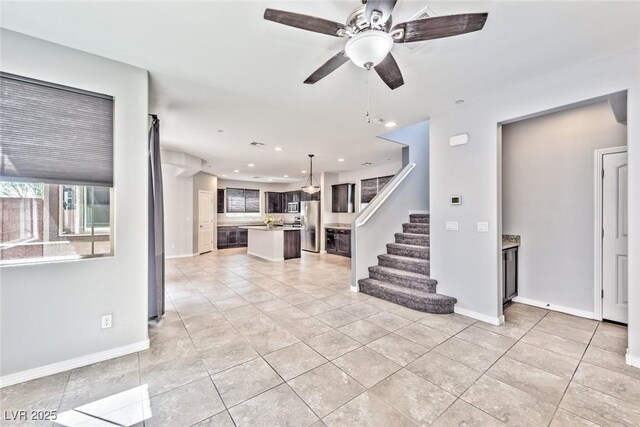 tiled living room featuring ceiling fan