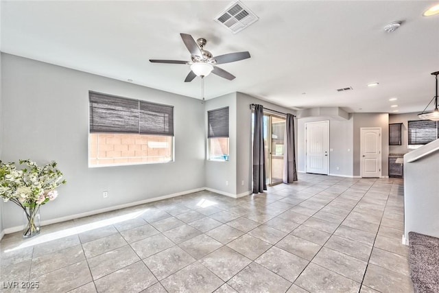 unfurnished living room featuring ceiling fan, baseboards, visible vents, and light tile patterned floors