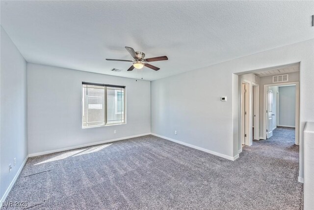 carpeted empty room featuring a textured ceiling and ceiling fan