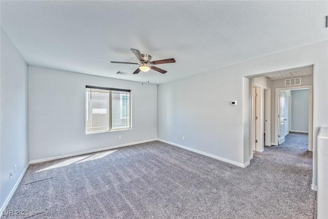 empty room with ceiling fan, baseboards, carpet flooring, and visible vents