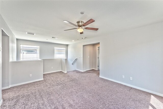 spare room featuring carpet floors and ceiling fan