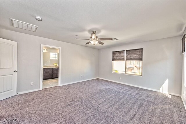 empty room featuring plenty of natural light, carpet floors, and ceiling fan