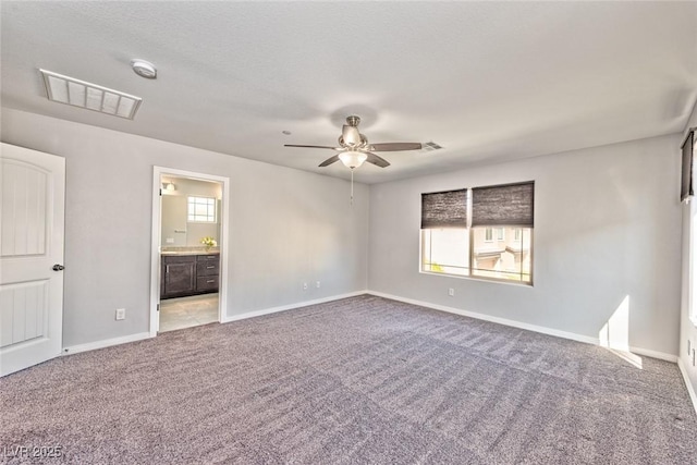 interior space with visible vents, baseboards, and ceiling fan
