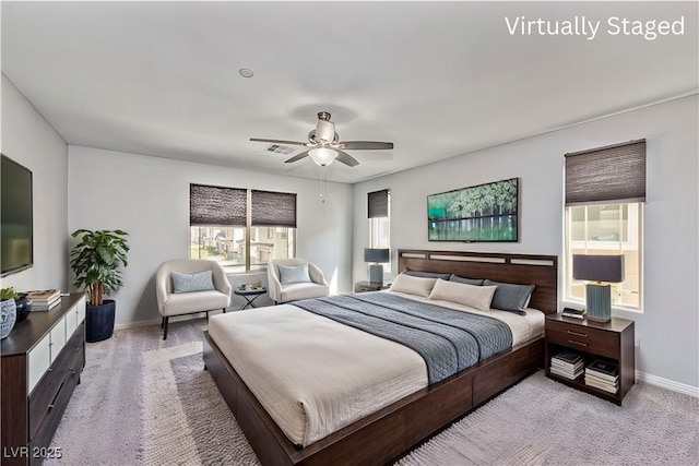 bedroom featuring ceiling fan, light carpet, visible vents, and baseboards