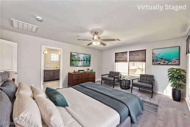bedroom with visible vents, a ceiling fan, connected bathroom, baseboards, and light colored carpet