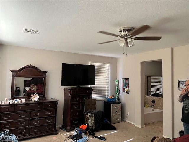 carpeted bedroom with ceiling fan and connected bathroom