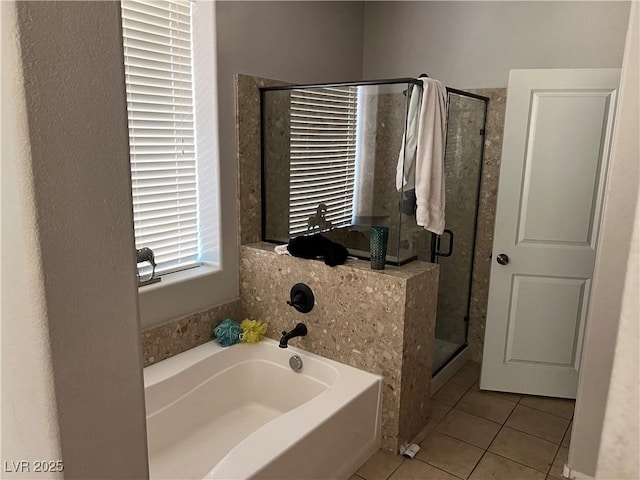 bathroom featuring tile patterned floors and shower with separate bathtub