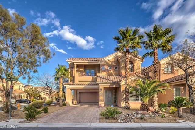 mediterranean / spanish house featuring a garage