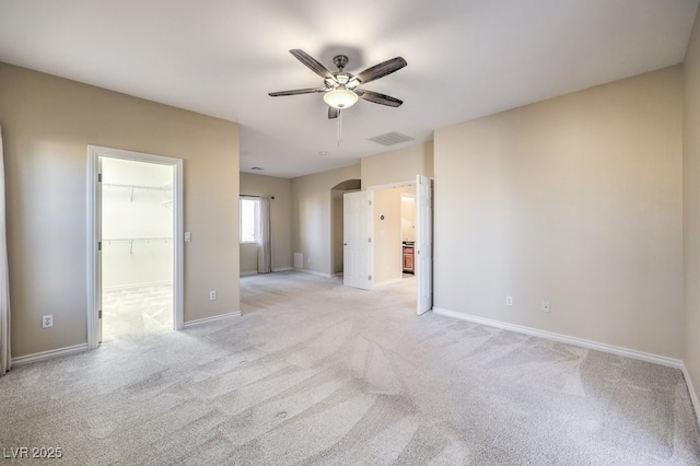 carpeted spare room with ceiling fan