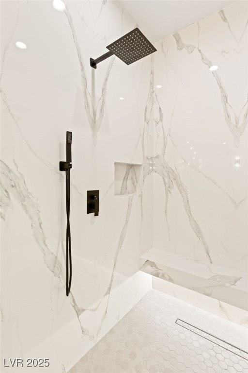 interior details featuring tiled shower