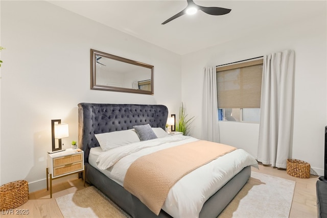 bedroom with ceiling fan and light hardwood / wood-style flooring