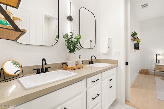 bathroom with vanity and wood-type flooring