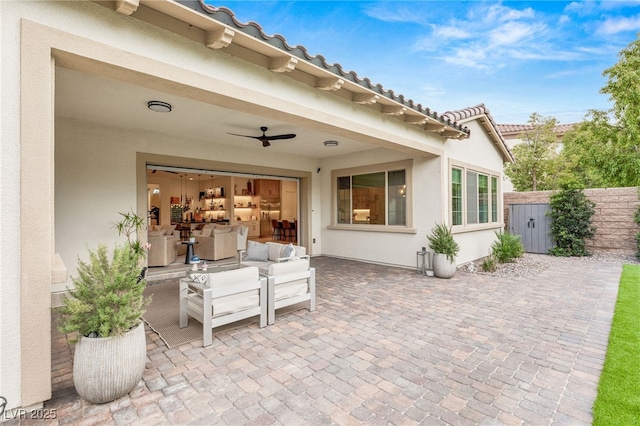 view of patio / terrace featuring ceiling fan and an outdoor living space