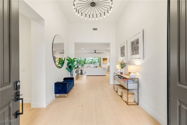 foyer with light wood-type flooring and ceiling fan