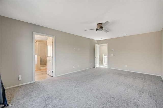 empty room featuring light colored carpet and ceiling fan