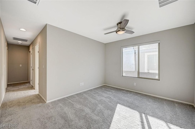 carpeted spare room with ceiling fan