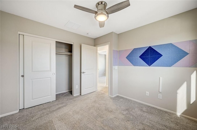 unfurnished bedroom featuring ceiling fan, light carpet, and a closet