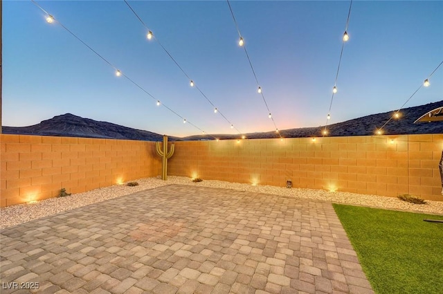 patio terrace at dusk with a mountain view