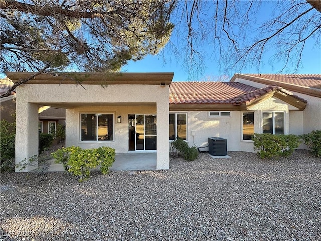 rear view of property with a patio area and central AC unit