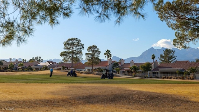 view of home's community featuring a mountain view and a lawn