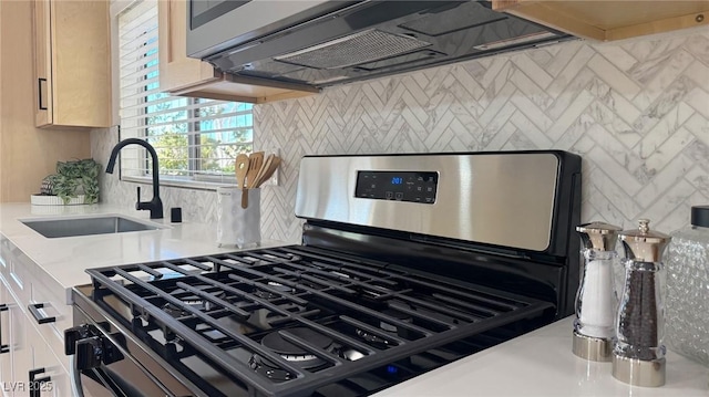 details with backsplash, sink, and gas range