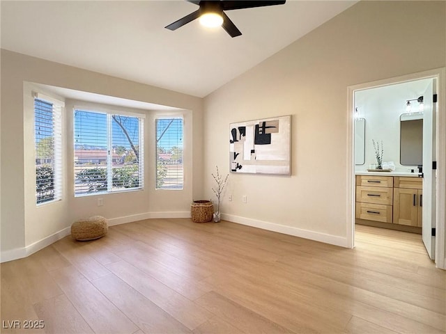 unfurnished room with light hardwood / wood-style floors, ceiling fan, and lofted ceiling