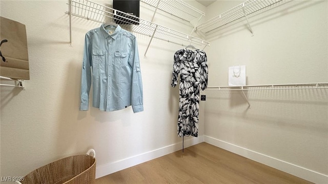 spacious closet featuring hardwood / wood-style floors