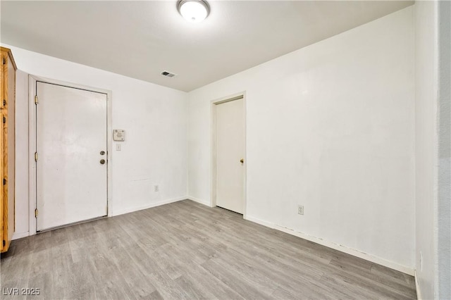 spare room with light wood-type flooring