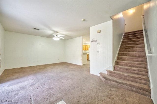 unfurnished living room featuring carpet flooring and ceiling fan