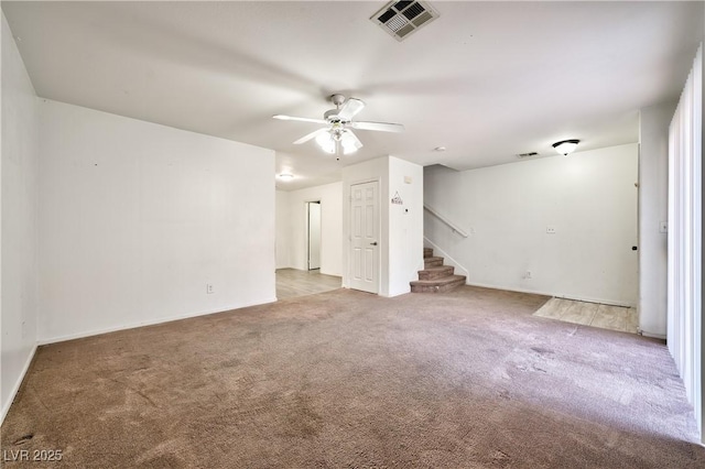 unfurnished living room featuring ceiling fan and carpet floors