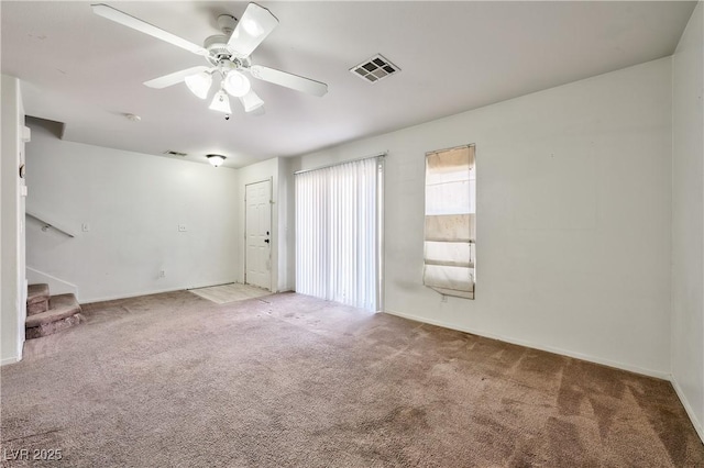 carpeted spare room featuring ceiling fan