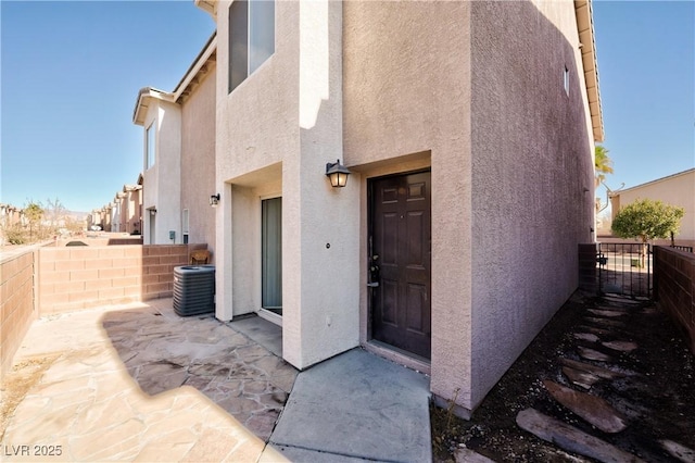 doorway to property featuring central air condition unit