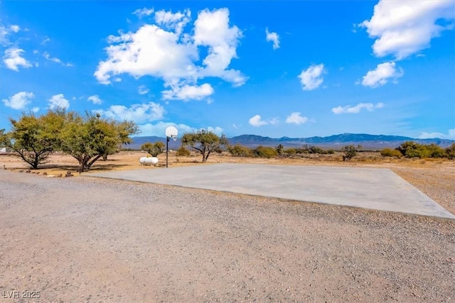 exterior space with a mountain view and basketball hoop