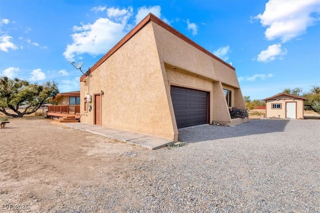 view of side of home featuring a storage shed and a deck