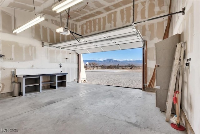 garage with a mountain view and a garage door opener