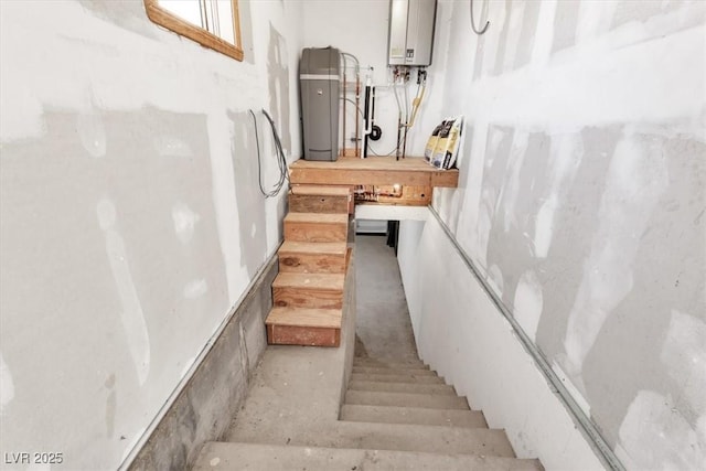 staircase featuring tankless water heater