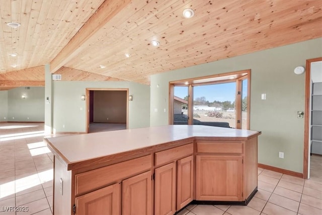 kitchen featuring a kitchen island, vaulted ceiling with beams, light brown cabinetry, light tile patterned flooring, and wood ceiling