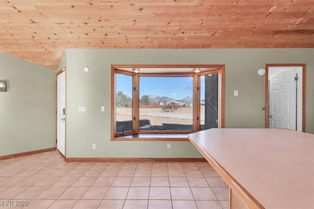 unfurnished dining area with wooden ceiling, light tile patterned floors, and vaulted ceiling