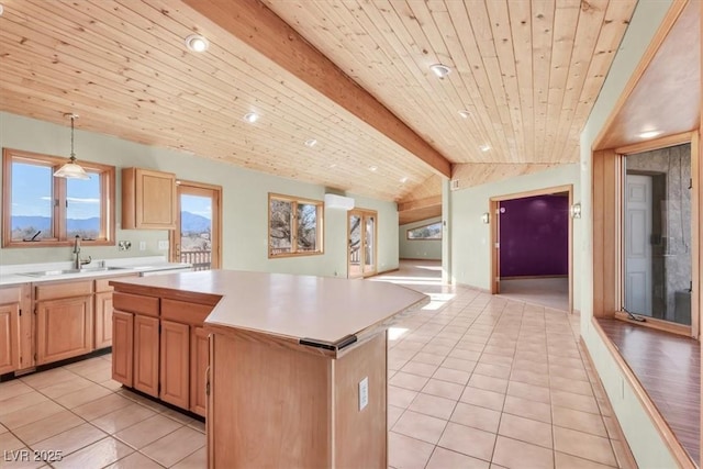 kitchen with sink, lofted ceiling with beams, wooden ceiling, a center island, and hanging light fixtures