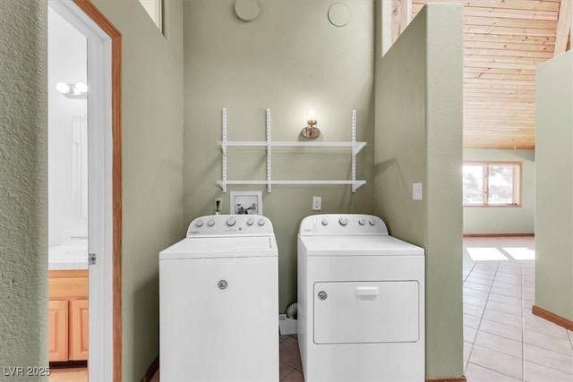 laundry area featuring light tile patterned floors and independent washer and dryer