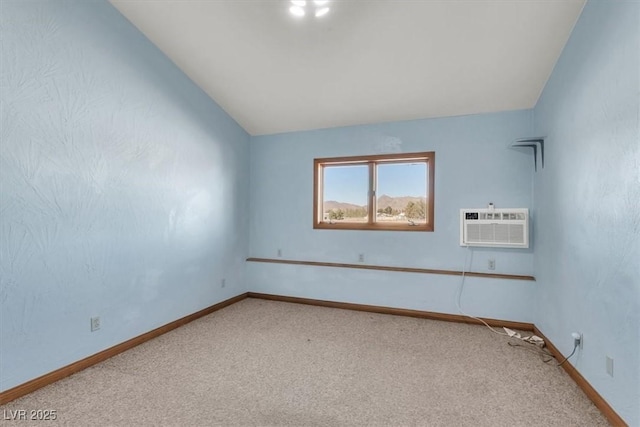 unfurnished room featuring carpet flooring, vaulted ceiling, and a wall unit AC