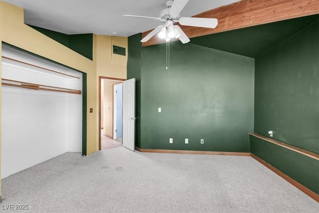 unfurnished bedroom featuring light carpet, a closet, high vaulted ceiling, and ceiling fan